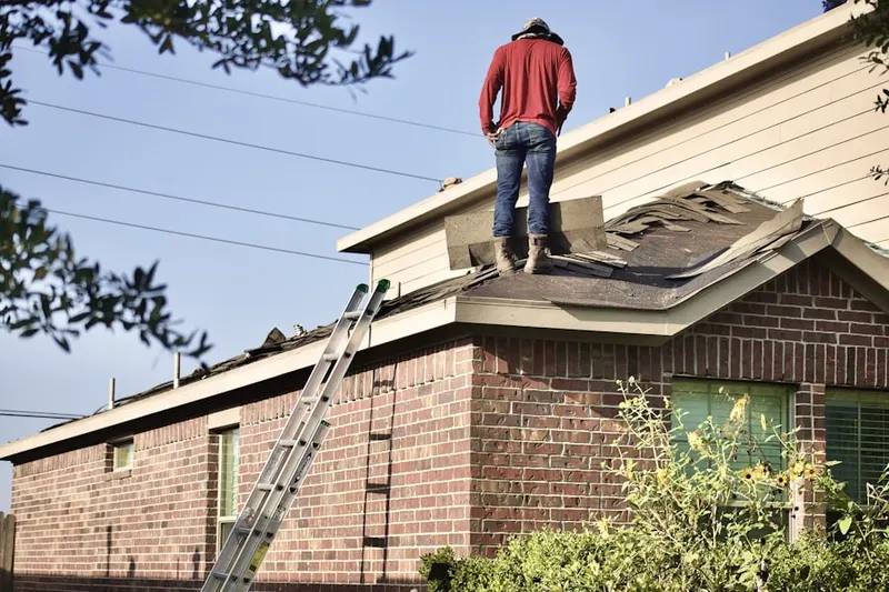 Professional roofer working on a residential roof in North Tahoe Regional Park